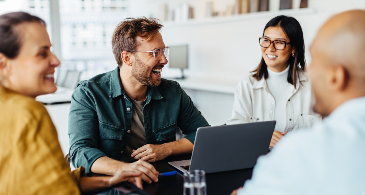 4 employees working laughing having fun