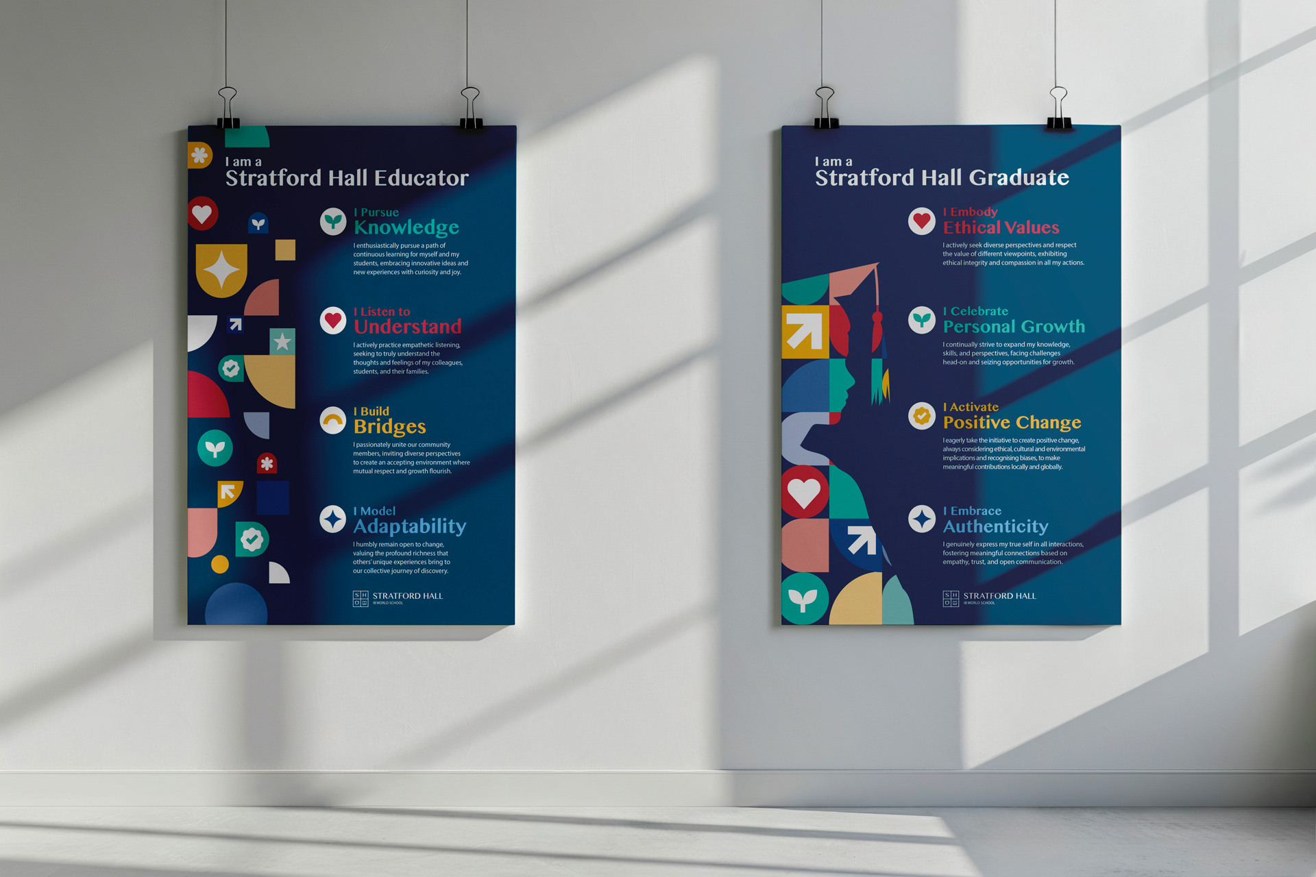 Two posters hanging on a wall with text about Stratford Hall’s values for educators and graduates, featuring geometric shapes and colorful icons.